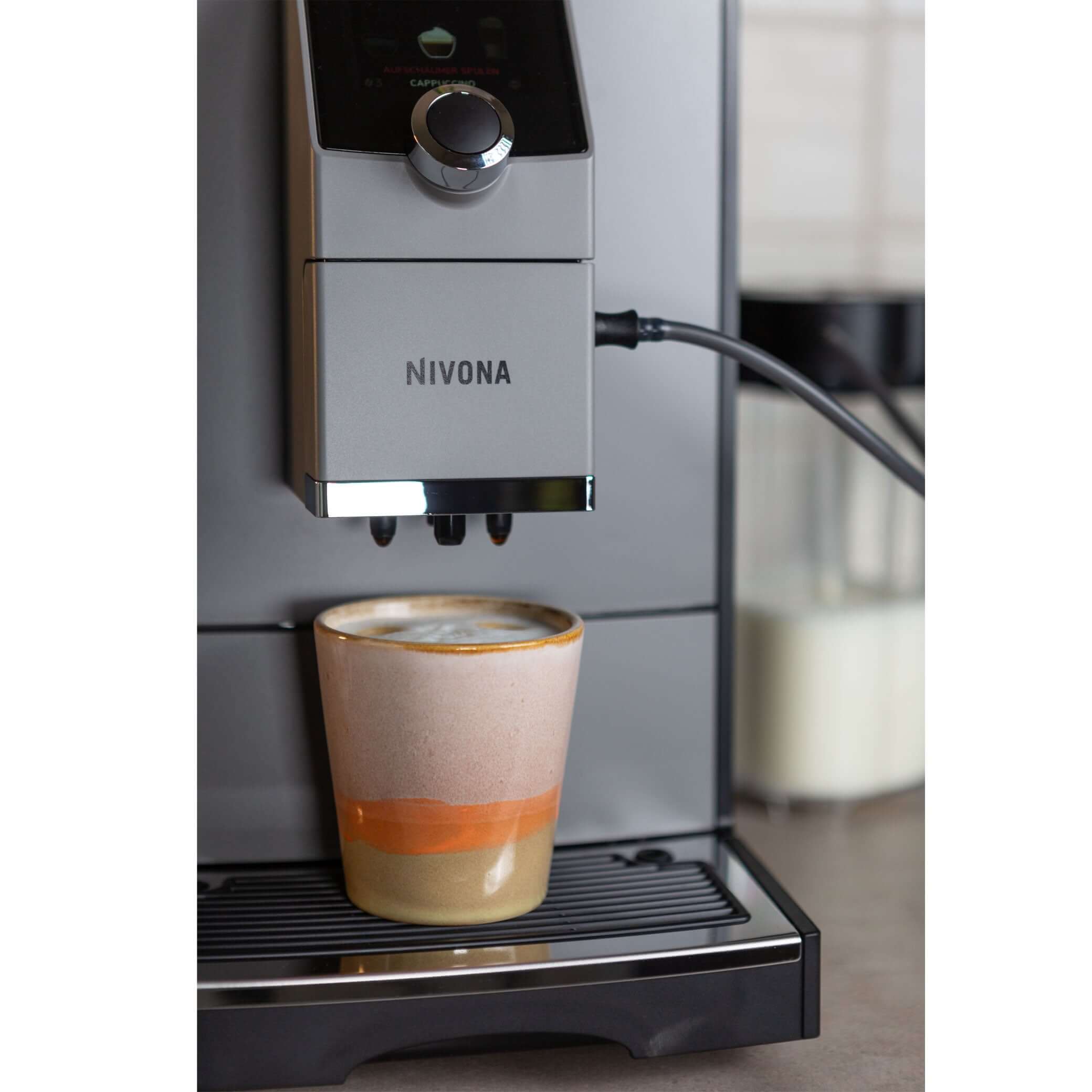 NICR 793 CafeRomatica Fully Automatic Espresso Machine brewing a cappuccino in a stylish mug.