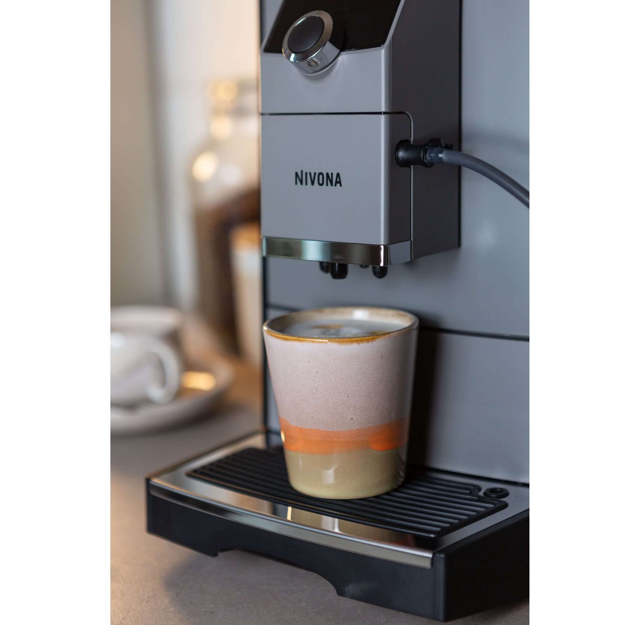 NICR 793 CafeRomatica Fully Automatic Espresso Machine brewing coffee into a ceramic cup.
