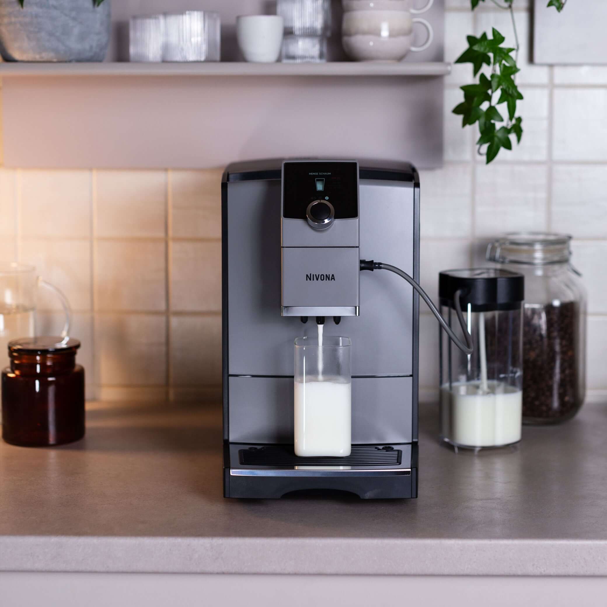 NICR 793 CafeRomatica Fully Automatic Espresso Machine brewing milk on a kitchen countertop.